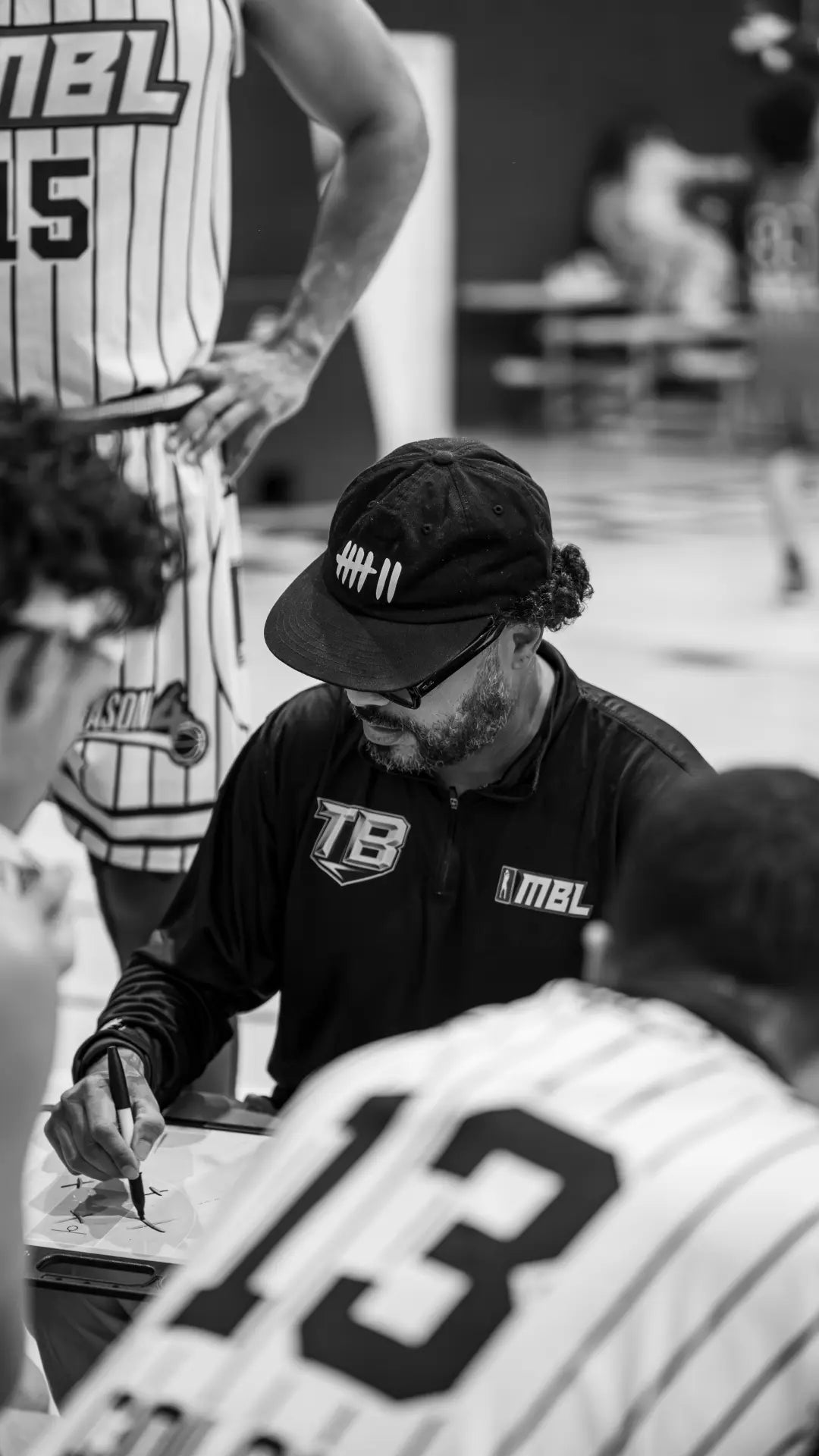 Klasico drawing up a play during a basketball huddle