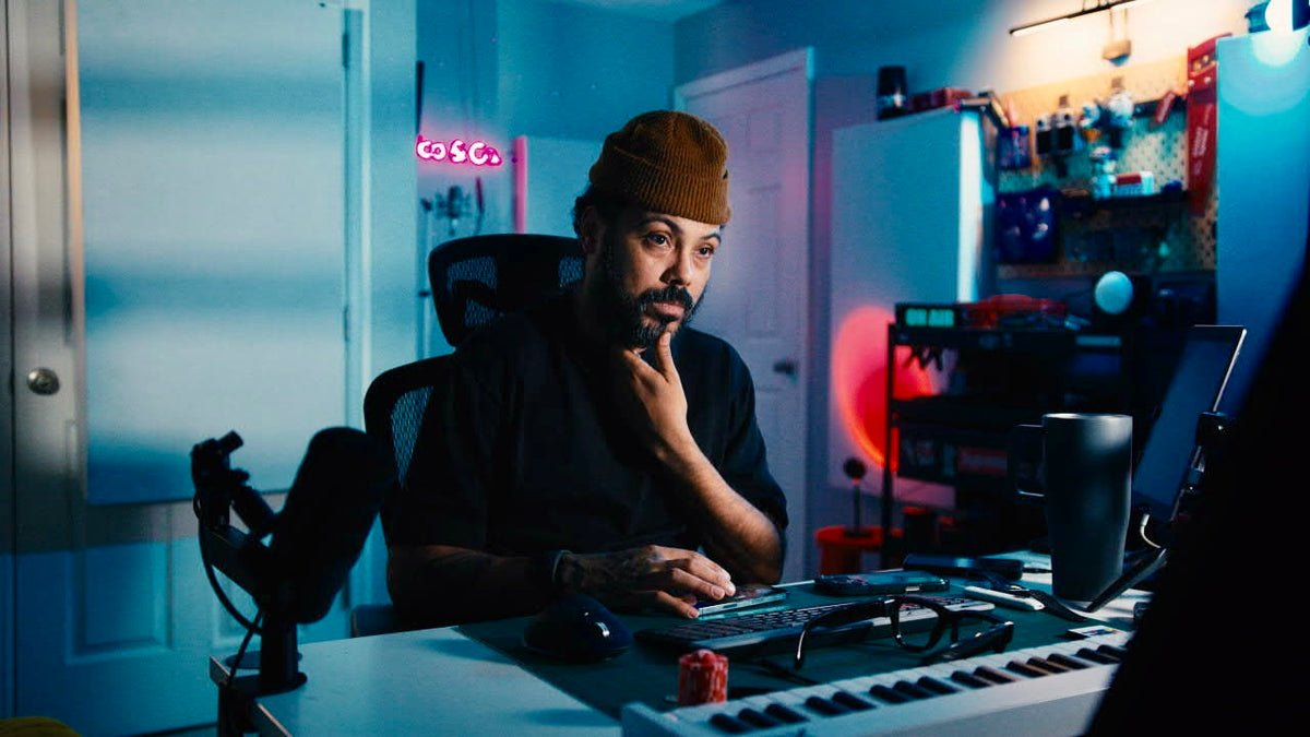 Klasico at work in his blue-lit music studio